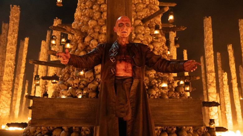 Dr. Kelson stands before an altar in 28 Years Later: The Bone Temple