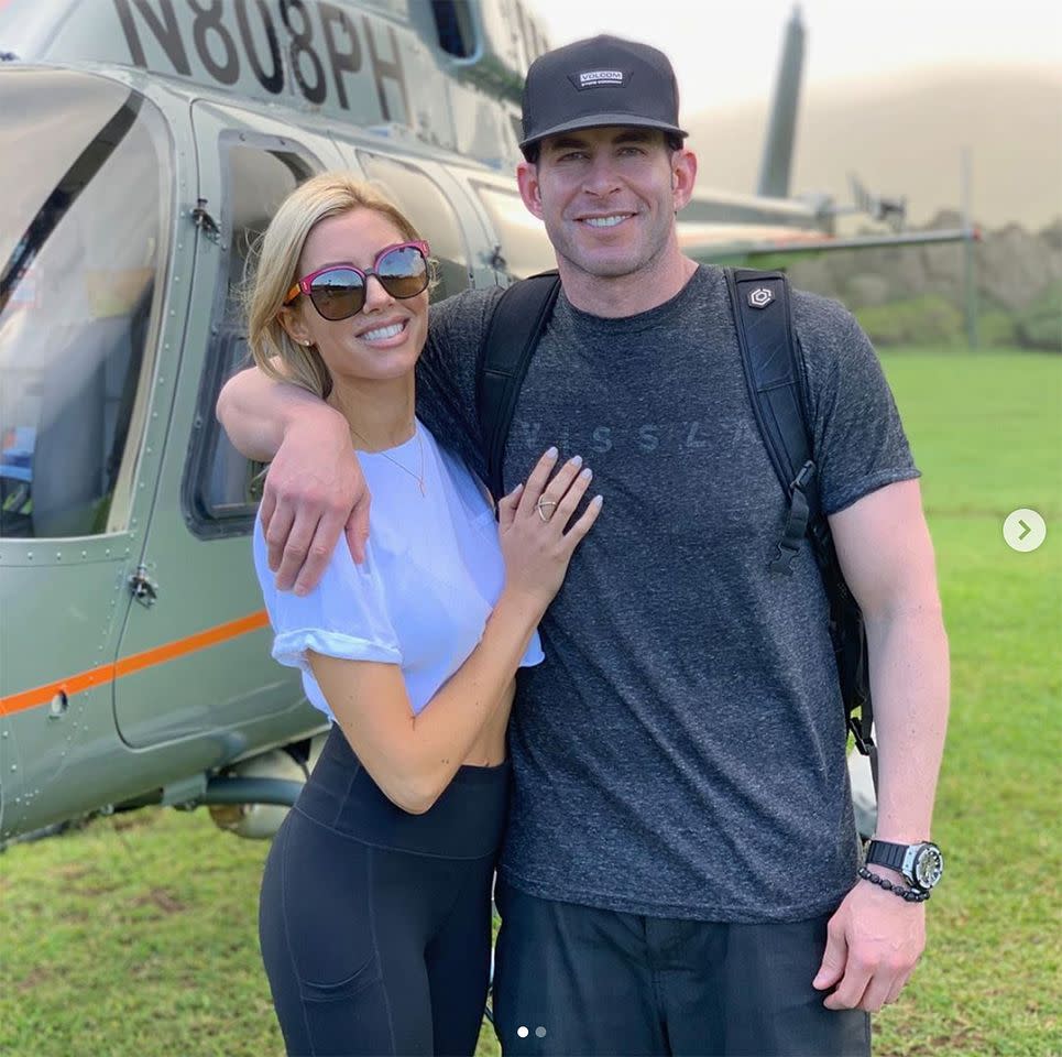 Heather Rae Young and Tarek El Moussa stand in front of a helicopter Heather Rae Young/Instagram