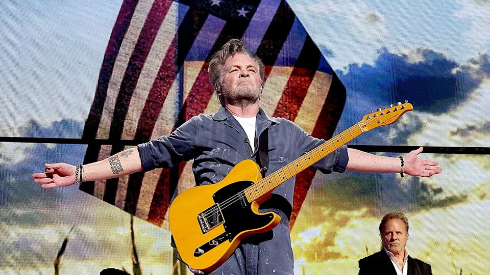 John Mellencamp performing in 2023 in front of the American flag