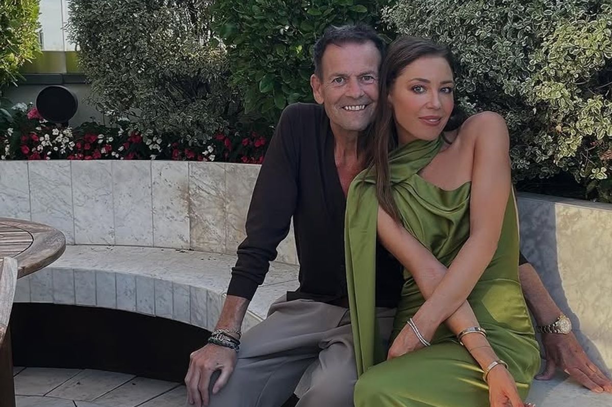 Lorna Luxe and her husband sitting together in an outdoor setting