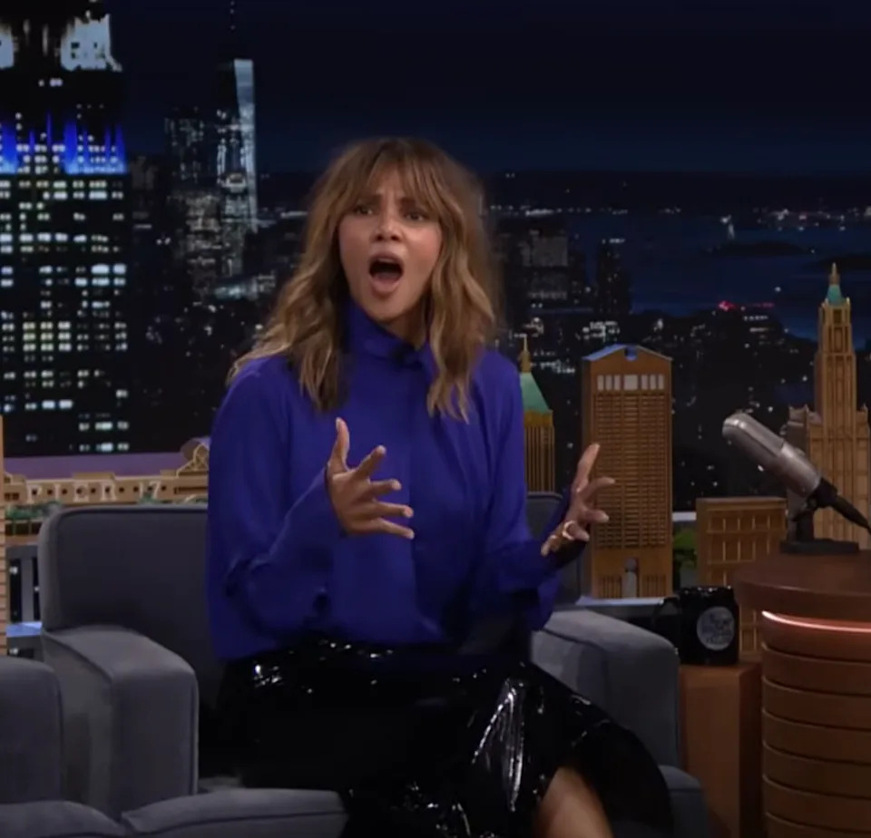 Halle Berry in a stylish outfit and the host share a laugh during a lively late-night talk show segment