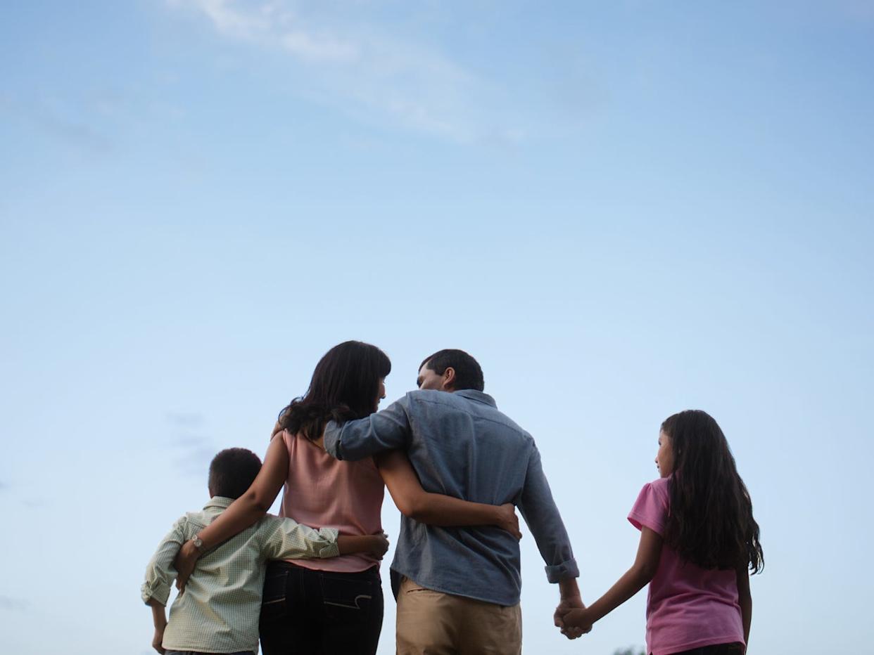 Family holding hands together.