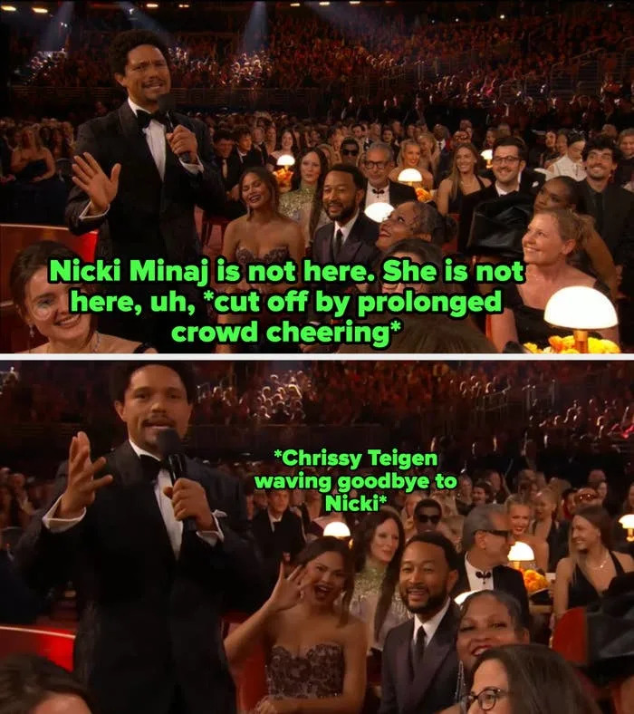 Person in tuxedo speaking to audience at an award event. The crowd is smiling and engaged, seated around small lit tables