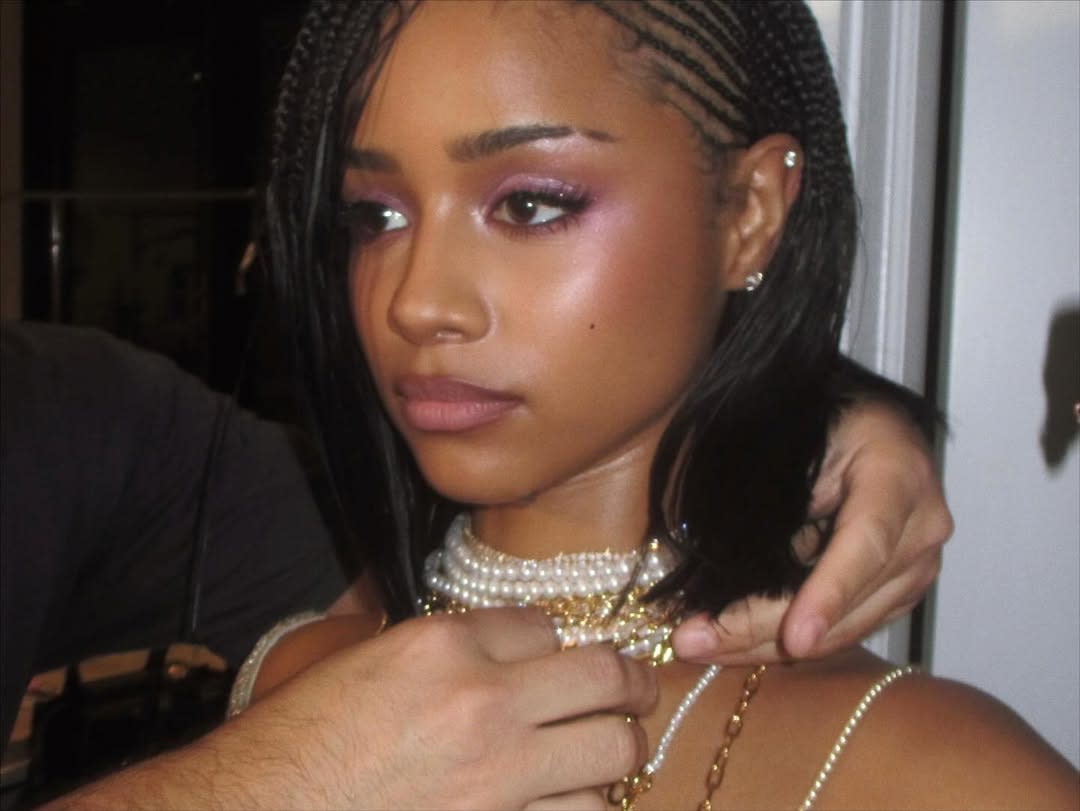 a person accessorizing with necklaces