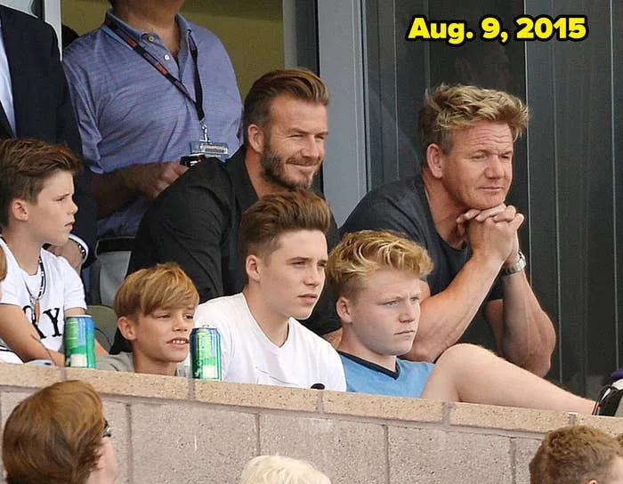 Group of people, including two adults and children, sitting in bleachers at an event, watching attentively