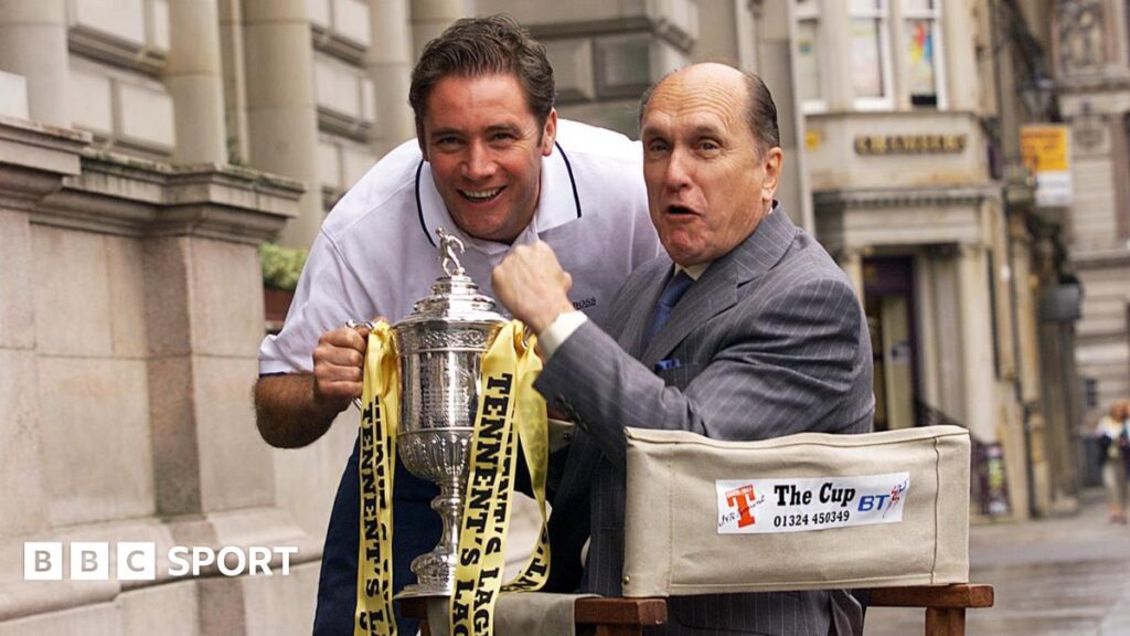 Robert Duvall: unlikely Scottish football cult hero Ally McCoist and Robert Duvall hold the Scottish Cup. Duvall is in a director's chair while McCoist is leaning forward in a white T-shirt.
