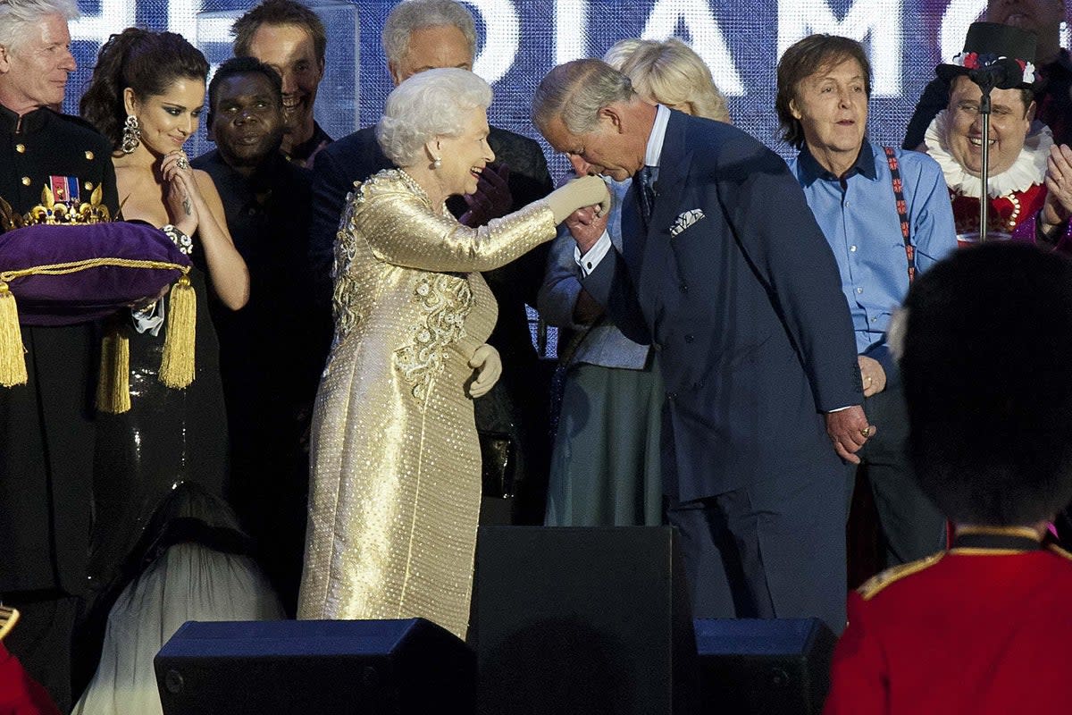 Queen Elizabeth II is greeted by her son, the Prince of Wales, as she is joined on stage with the rest of the Royal family and performers at the end of the Diamond Jubilee Concert at Buckingham Palace (PA)