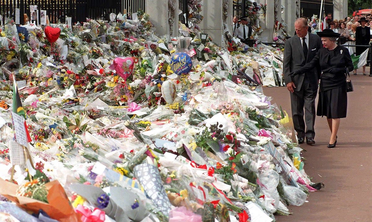 The Duke of Edinburgh and Queen Elizabeth view the thousands of flowers and tributes left outside Kensington Palace in memory of Diana, Princess of Wales, on September 5, 1997 (AFP/Getty)