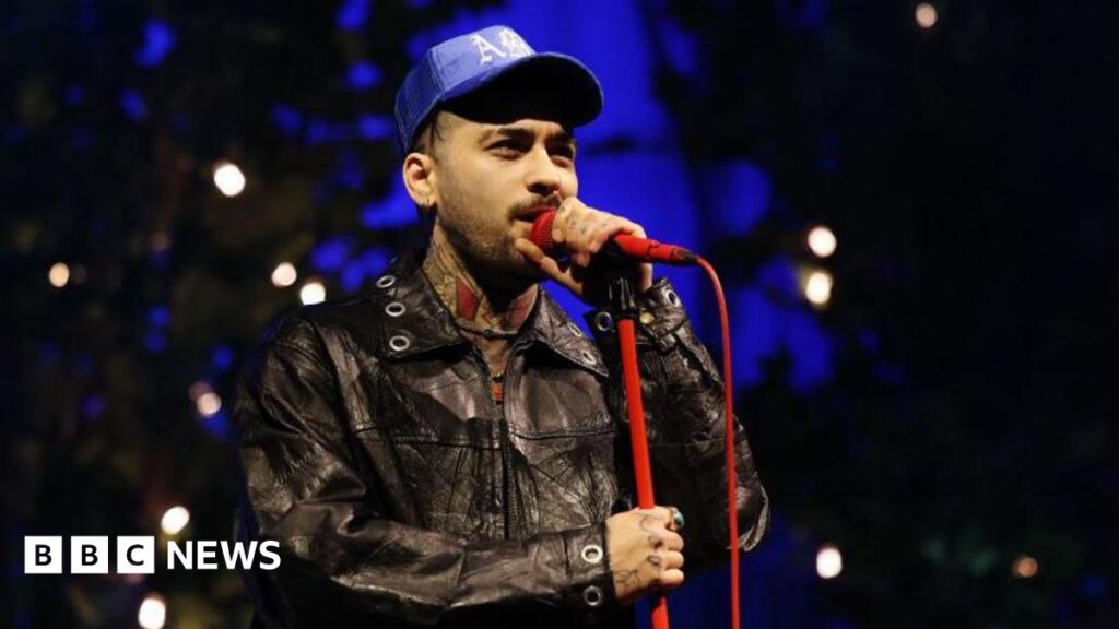 Zayn Malik announces new album Konnakol and biggest solo tour Zayn Malik singing into a red microphone while performing at O2 Academy Leeds