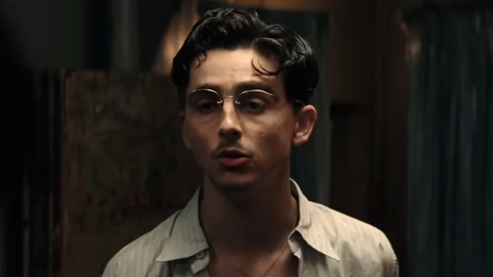 A close up of Timothee Chalamet wearing glasses in Marty Supreme