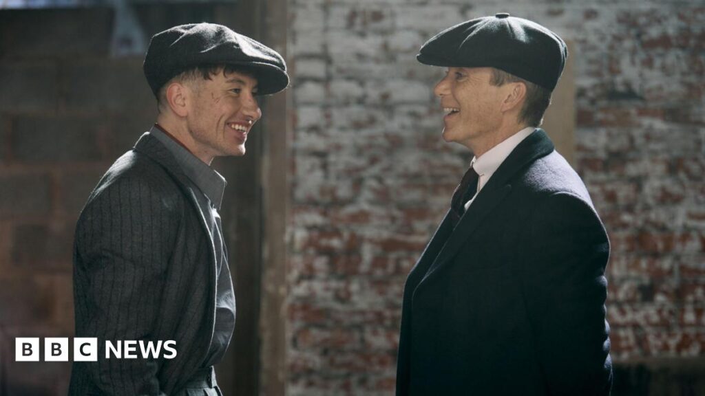 Calke Abbey: Derbyshire stately home used for Peaky Blinders film shoot Two actors in formal dress wearing flat caps in conversation. One man is Cillian Murphy stood on the right, the other is Barry Keoghan.