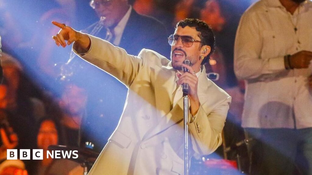 Puerto Rican singer Bad Bunny points to the audience while at a microphone stand during his second show of the Debi Tirar Mas Fotos World Tour at Atanasio Girardot Stadium in Medellin, Colombia, 24 January 2026.