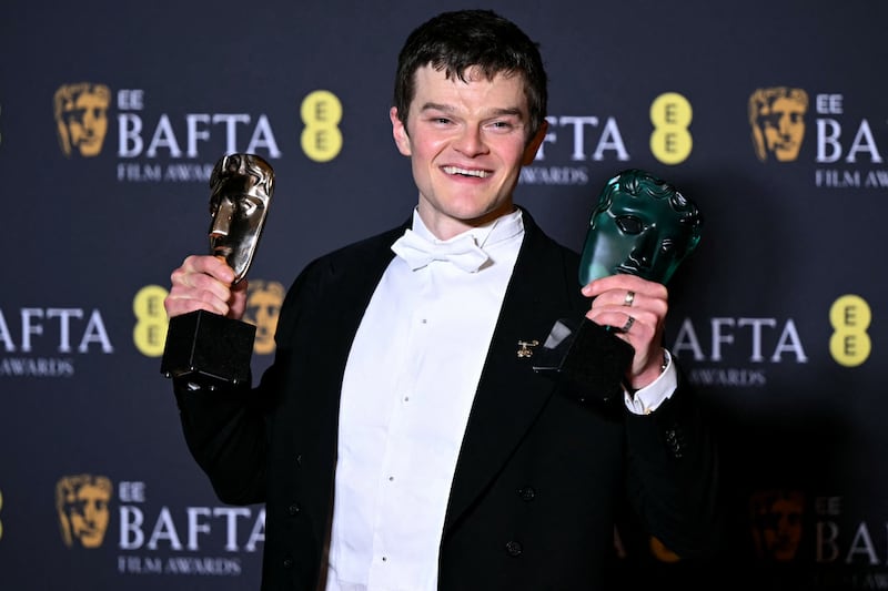 British actor Robert Aramayo poses with the awards for best leading actor and rising star. Photograph: Justin Tallis/AFP via Getty
