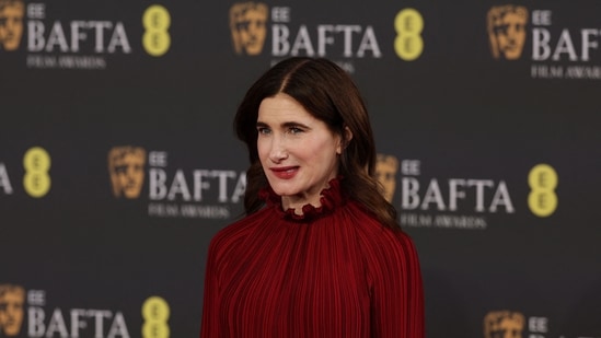 Kathryn Hahn posed with style in a red ruffled gown. In the sea of white and black ensembles at the event, this look stood out because of the vibrant colour. (AFP)