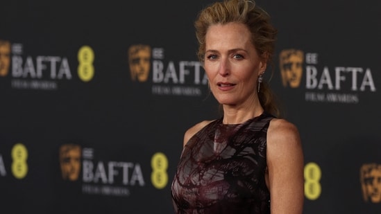 US actor Gillian Anderson wore a brown ensemble, sticking to the eveningwear staple. Her hair was styled in a neat, voluminous bun, which made her look striking and stylish.(AFP)