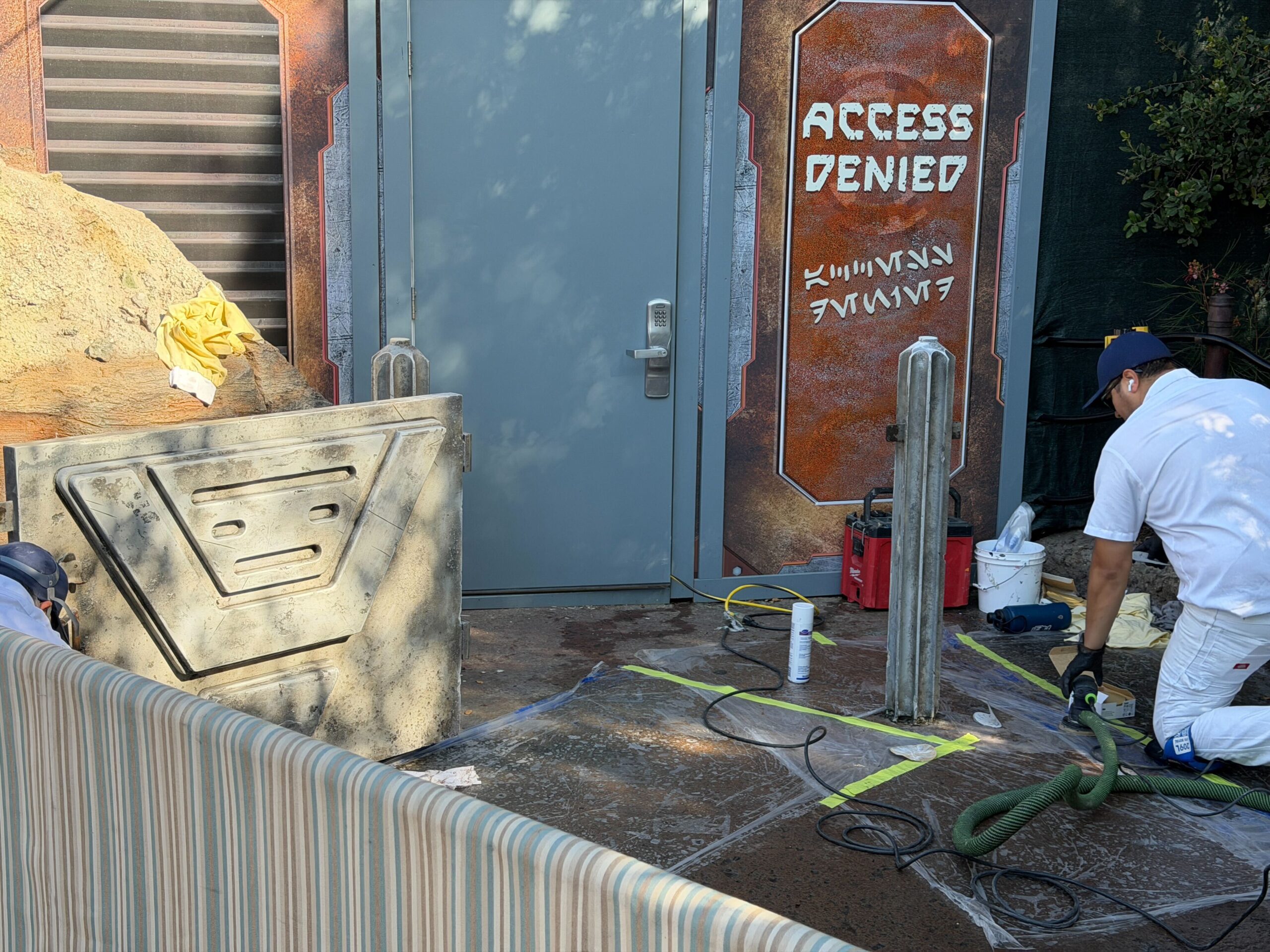 The cast members informed us that they were sanding the first layer off and replacing it with a