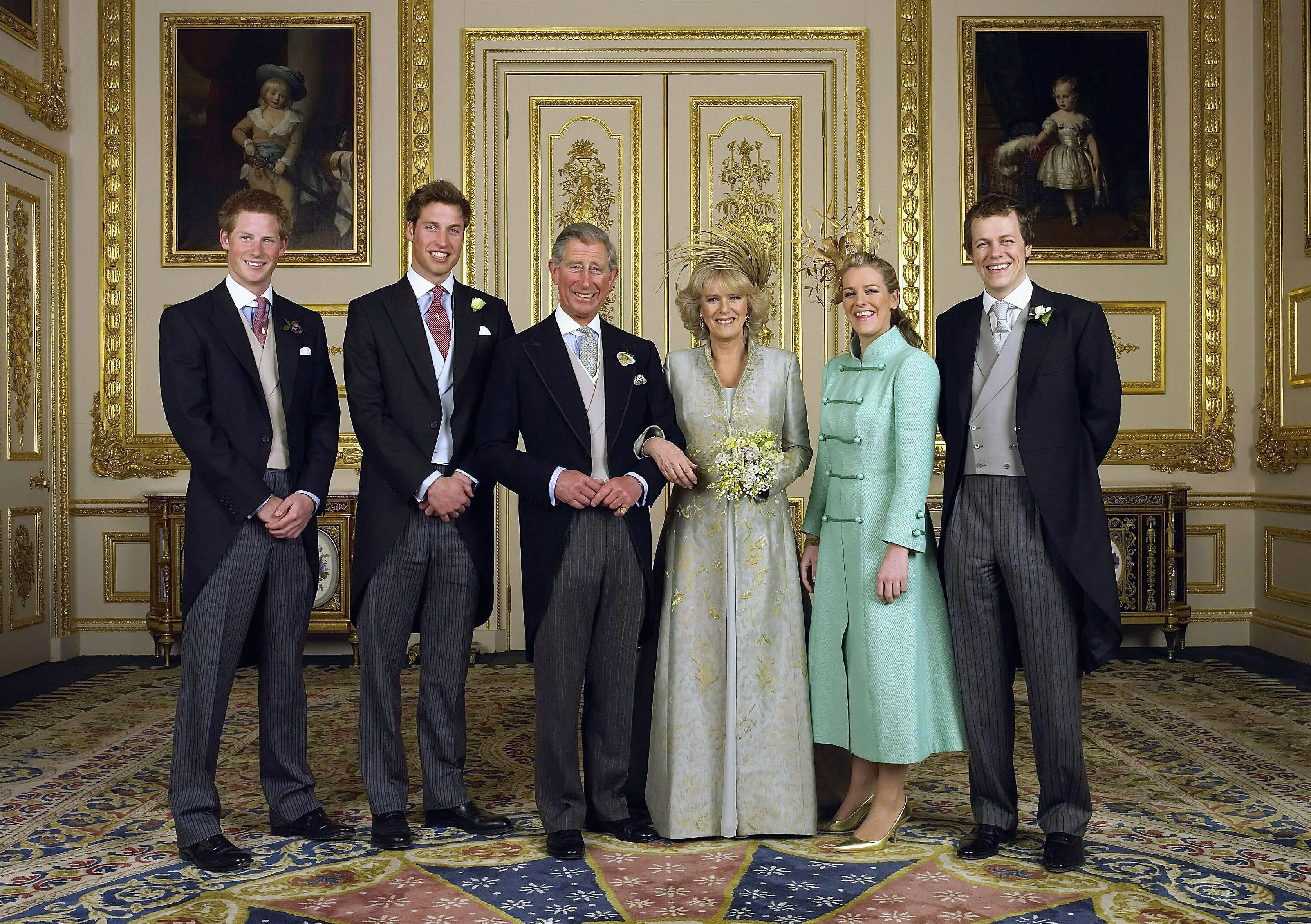 King Charles and Queen Camilla posing for a formal portrait with their children on their wedding day