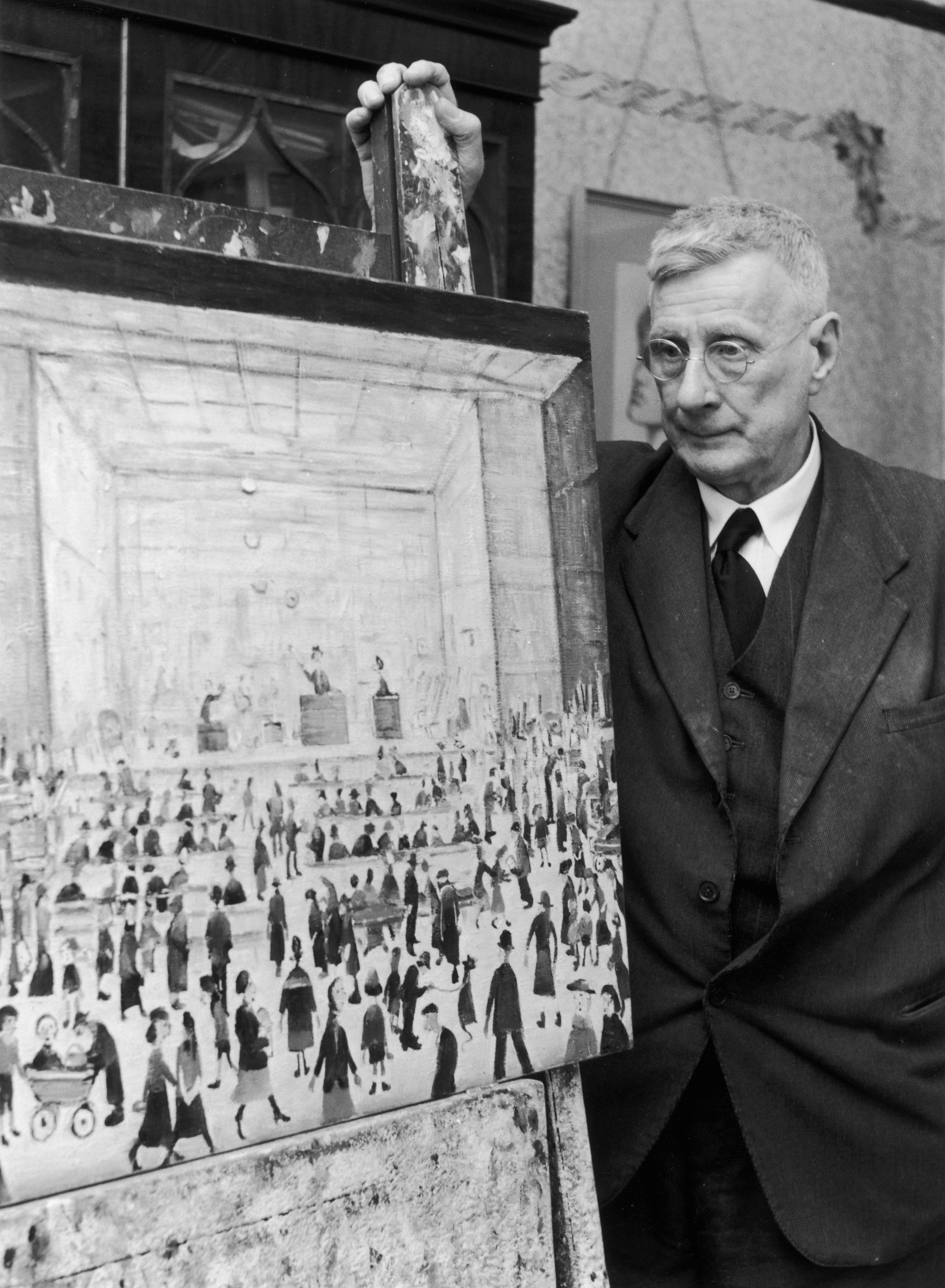 April 1958: Lowry in his home at Mottram in Longdendale, Cheshire standing by one of his famous images of ‘matchstick men’