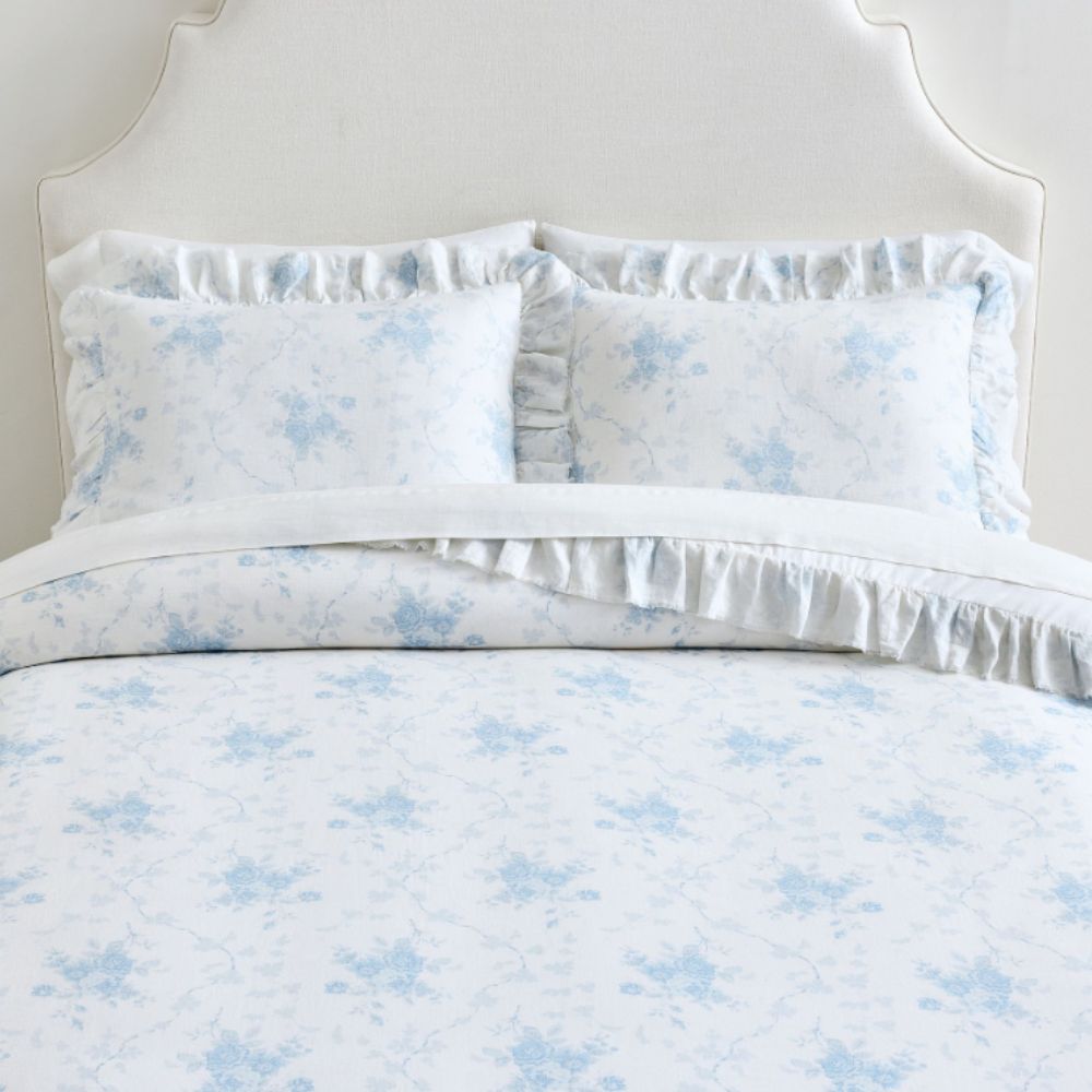 Blue and white floral bedding with ruffle trim