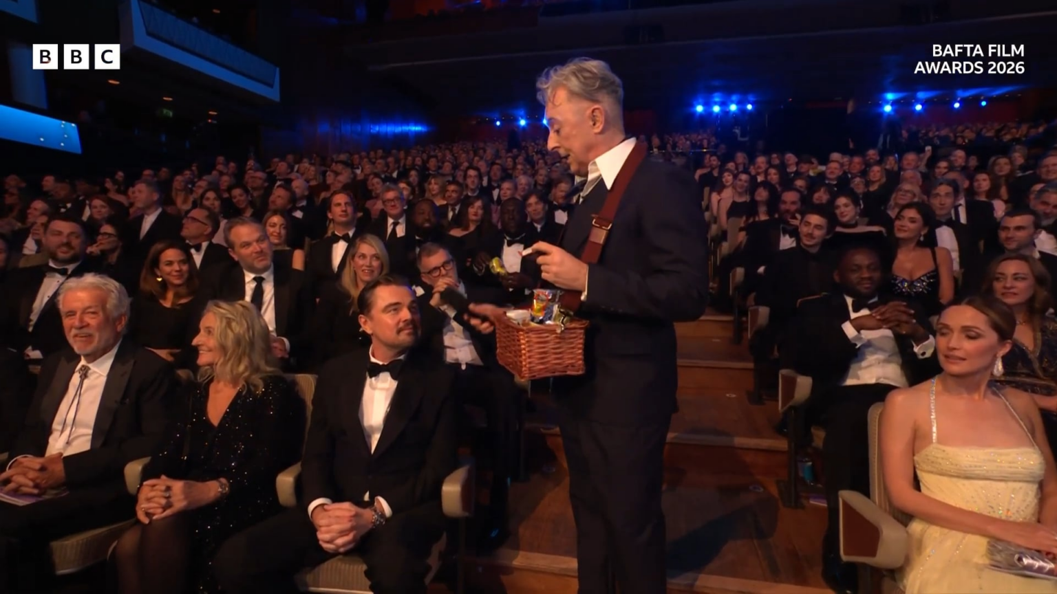 Alan Cumming passes out British snacks to celebrities at the BAFTAs: "Kylie, have you ever had your gums around a giant Jammie Dodger?"