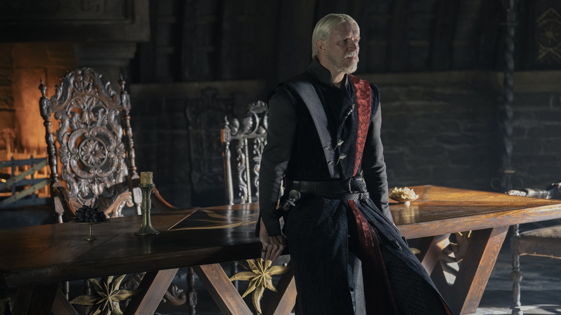 Maekar Targaryen (Sam Spruell) sits on a table in a scene from "A Knight of the Seven Kingdoms" episode 6