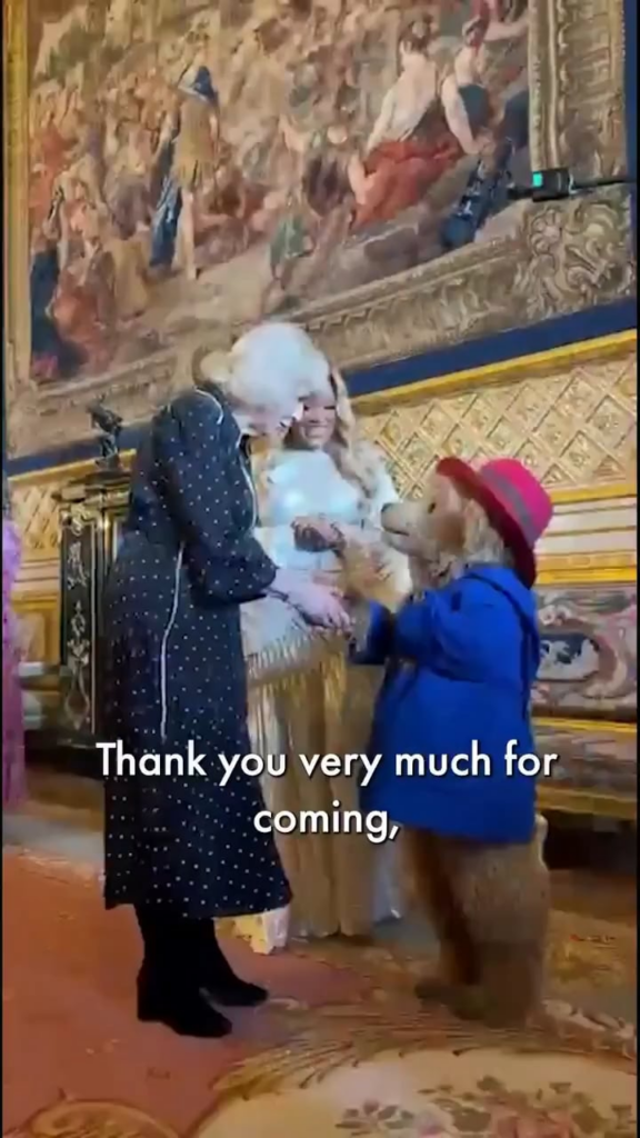 Queen Camilla greets Paddington Bear and Marisha Wallace during a reception at Windsor Castle today, to celebrate the final of BBC's creative writing competition