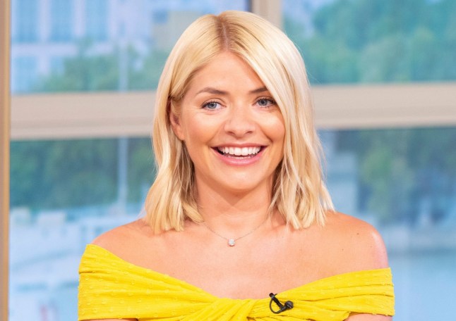 A close up of Holly Willoughby in a yellow dress