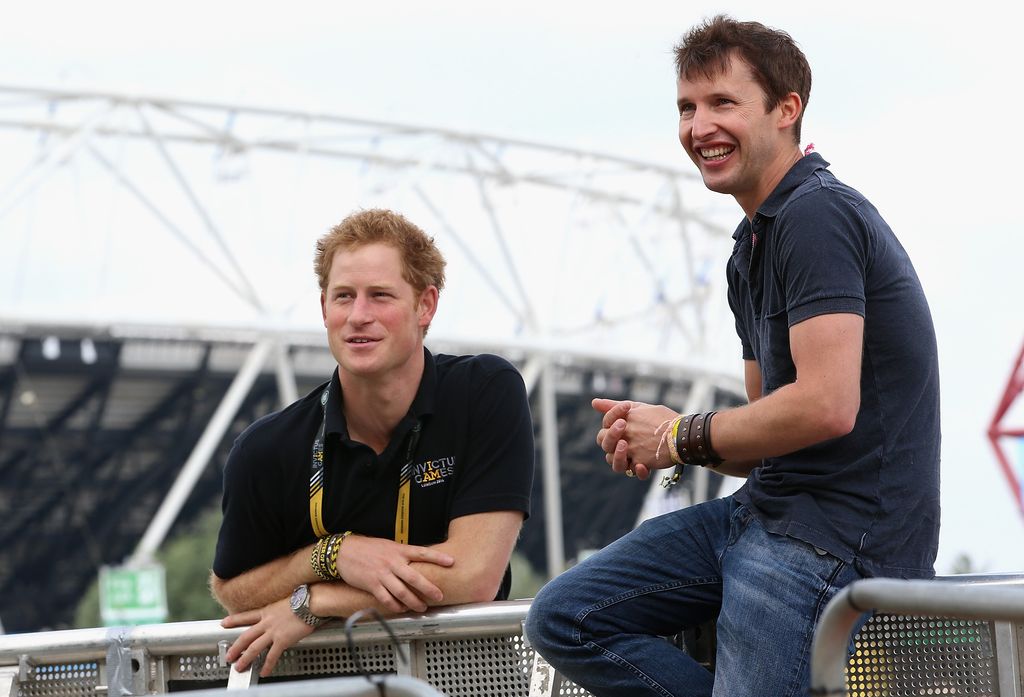 Prince Harry chats with singer James Blunt as he rehearses for the Invictus Games Closing Ceremony in 2014