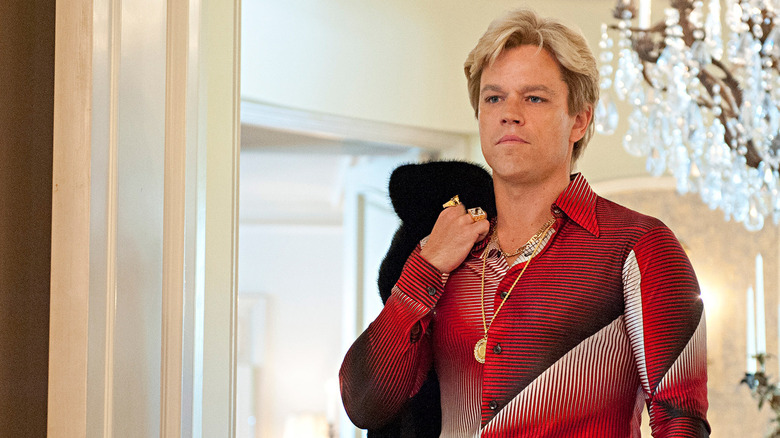 Scott Thorson (Matt Damon) tersely drapes a coat over his shoulder in Behind the Candelabra