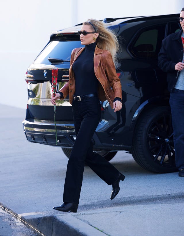 *exclusive* los angeles, ca bella hadid looks stylish as she made her way to her first job of the new year. the tall model arrived at milk studios carrying a pretty red rose, as she met with a pal on her way in. she wore a vintage leather jacket, sleek black bodysuit and heeled black boots. she carried a prada aimee bag on her shoulder.pictured: bella hadidbackgrid usa 6 january 2026 usa: +1 310 798 9111 / usasales@backgrid.comuk: +44 208 344 2007 / uksales@backgrid.com*uk clients pictures containing childrenplease pixelate face prior to publication*