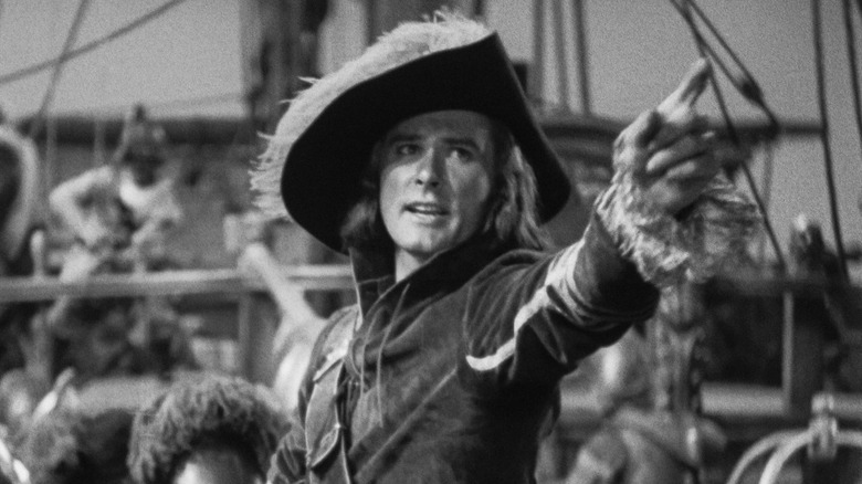 Errol Flynn as Peter Blood points to the horizon in Captain Blood.