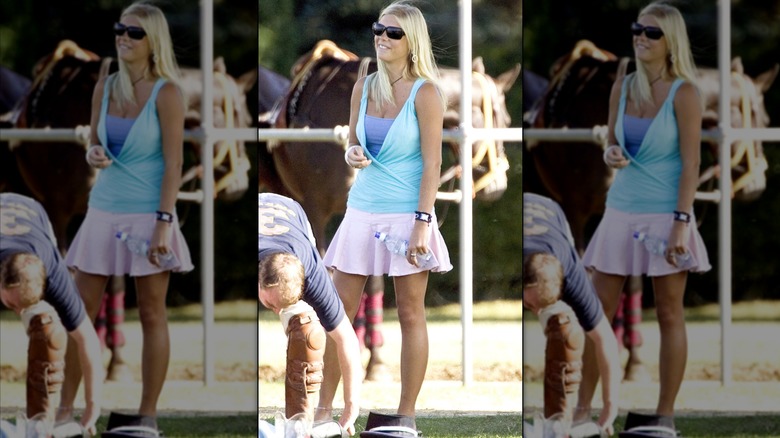 Chelsy Daly wearing a pink miniskirt and layered blue tops at a polo match