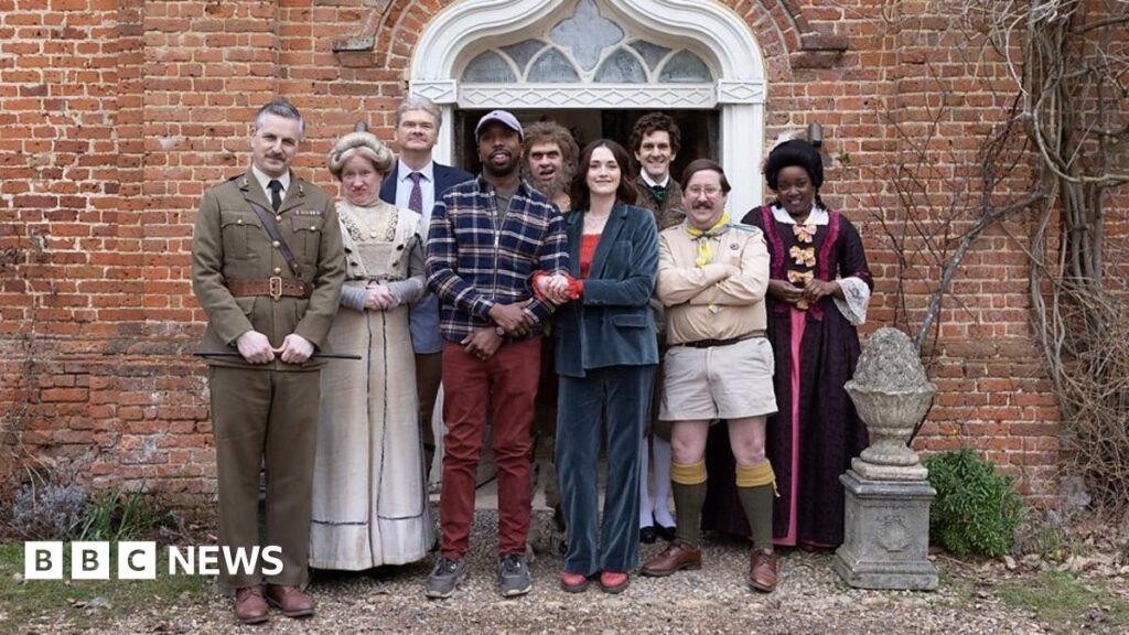 Cast photo of the characters from the show outside Button House, in costume