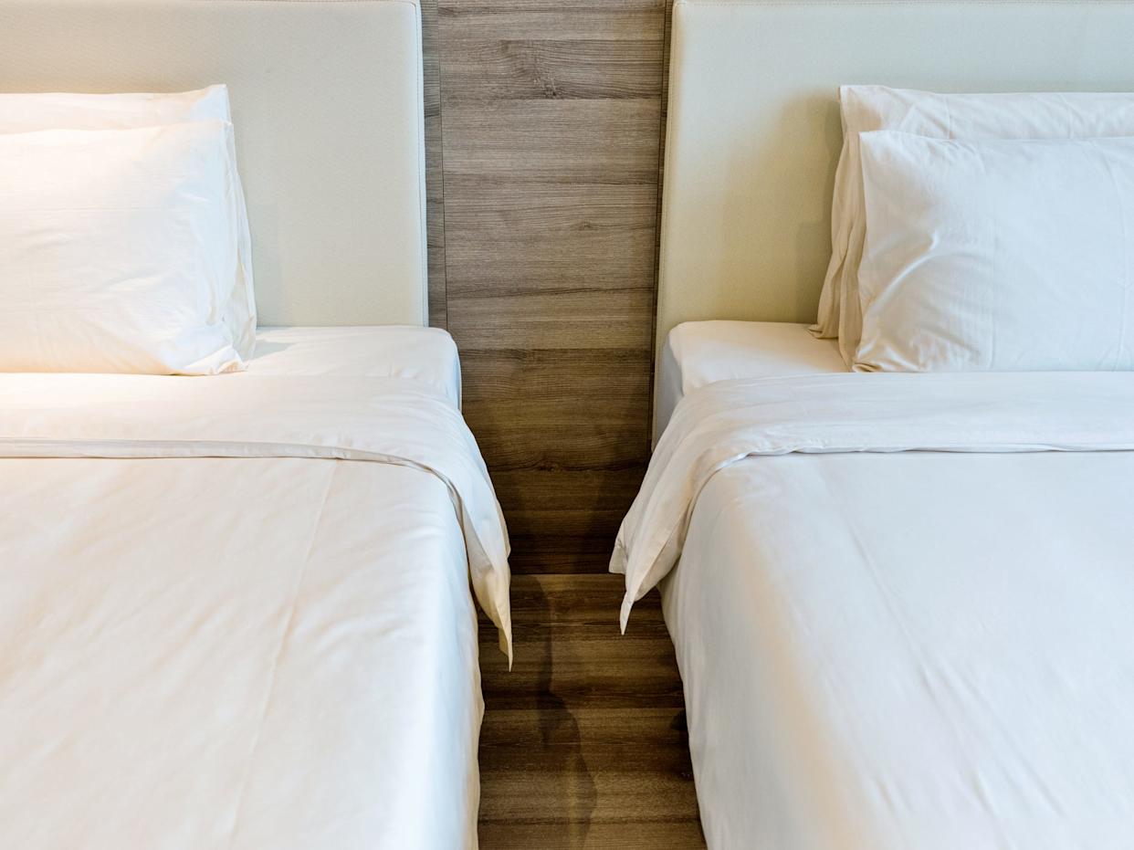 Two beds in a hotel room.