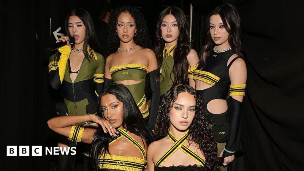 Katseye girl group’s Mannon Bannerman steps away to focus on health Six-member girl group Katseye in black, yellow and green outfits at the Grammy Awards.