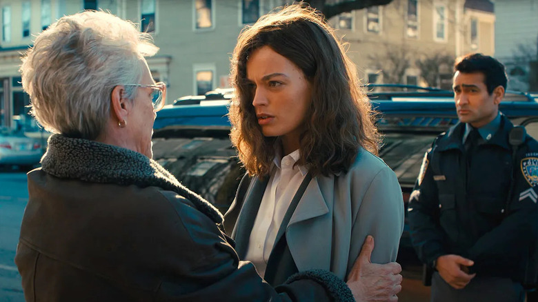 Emma Mackey as Ella McCay, speaking to Jamie Lee Curtis as Helen McCay with Kumail Nanjiani as Nash behind her in Ella McCay