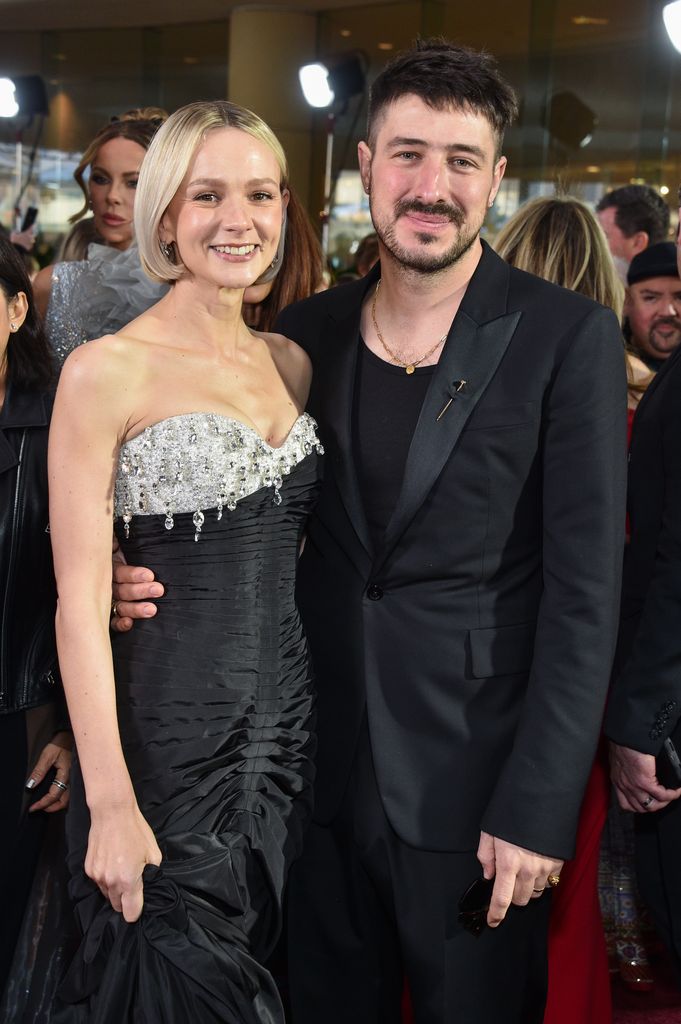 Carey Mulligan in a black, crystal studded dress with husband Marcus Mumford.