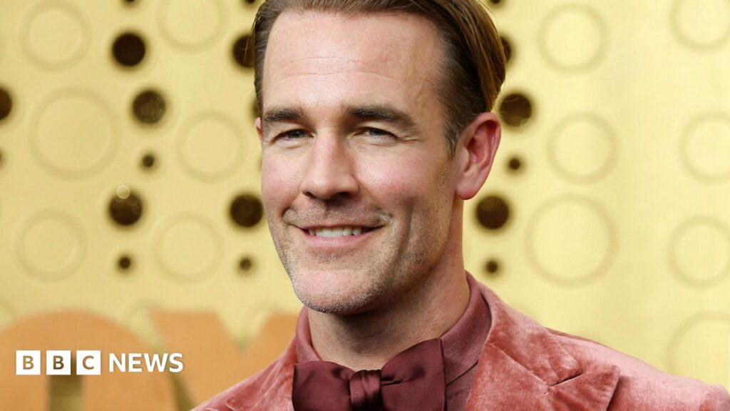 James Van Der Beek wearing a maroon dickie bow while smiling for the cameras on arrival at the 2019 Emmy Awards