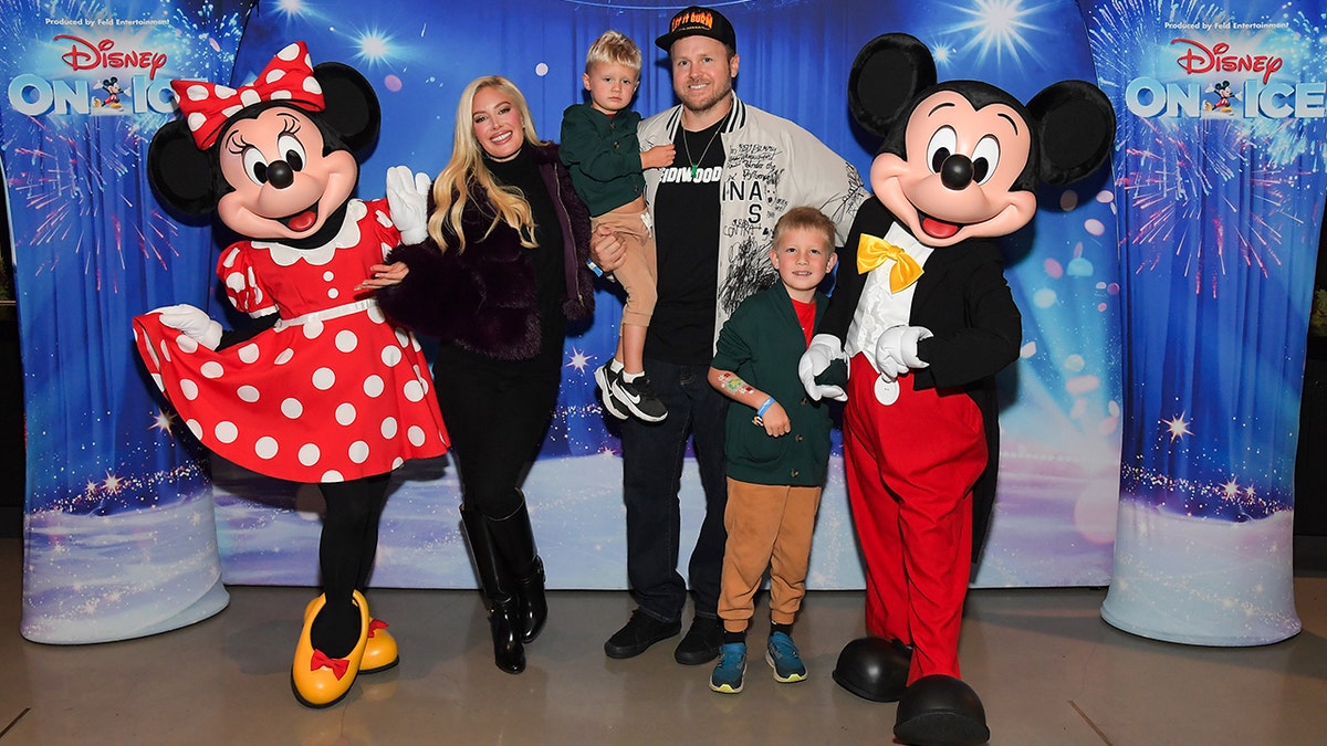 Heidi Montag and her family posing with Mickey and Minnie at Disney On Ice in December 2025.