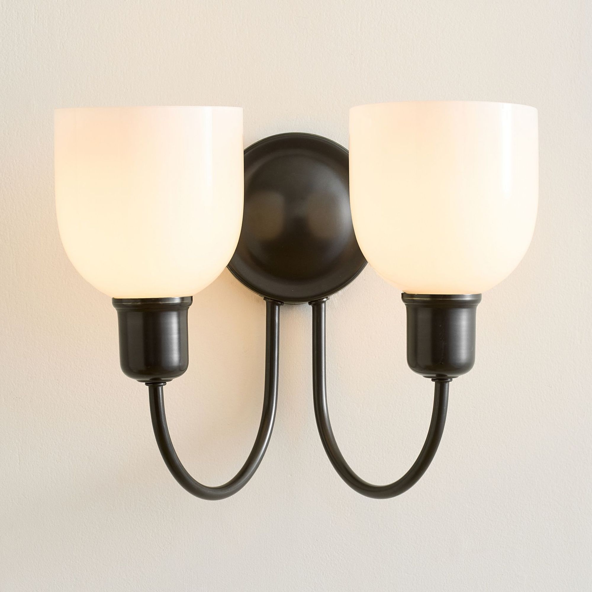 Bronze double wall sconce with frosted glass shades