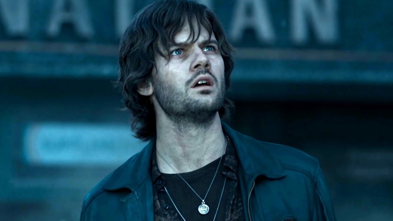 Chris looks up, concerned in 