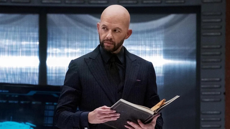 Jon Cryer as Lex Luthor, reading a book on Supergirl