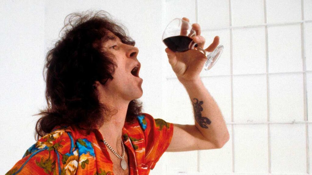 Bon Scott: 80th Birthday Celebration plans announced Bon Scott drinking a glass of wine