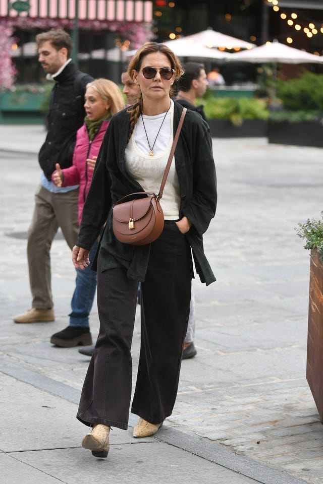 new york, new york october 29: katie holmes spotted with her hair in a long braid and wearing a demellier bag on october 29, 2025 in new york city. (photo by michael simon/getty images for demellier)