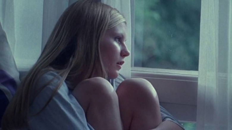 Lux looking out a window in The Virgin Suicides