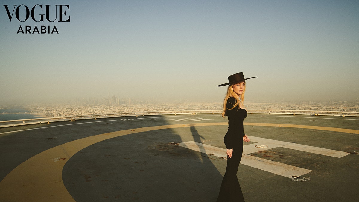 Lindsay Lohan in an all black outfit on a helipad in Dubai.