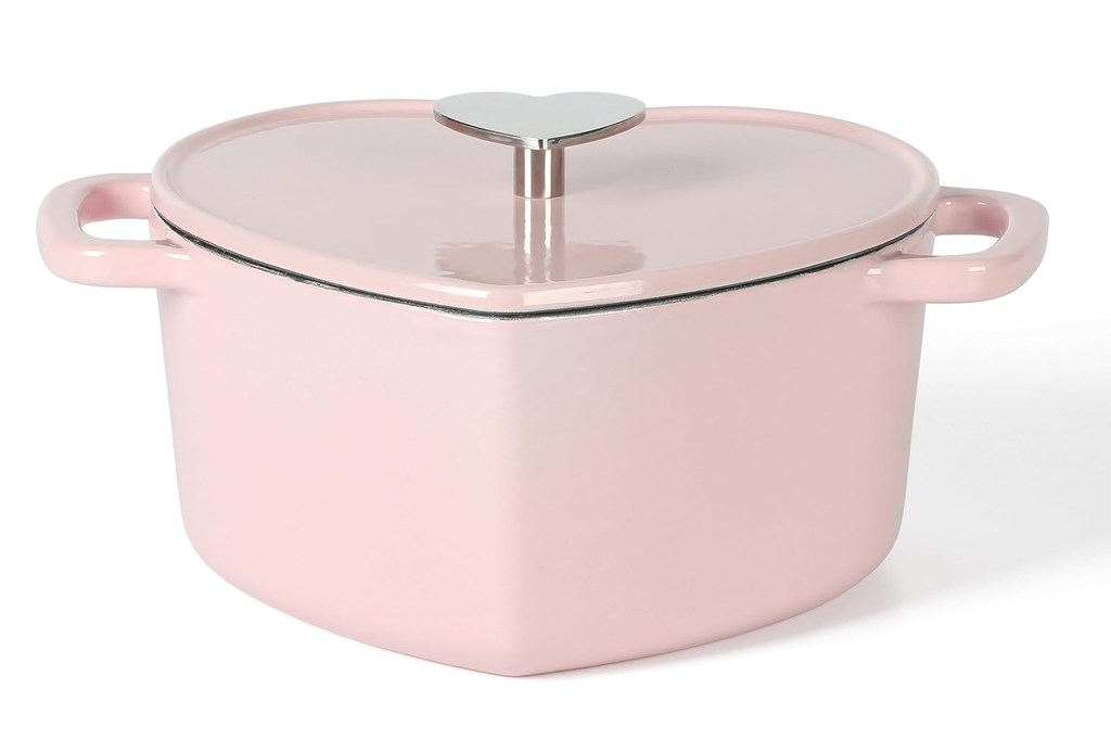 Pink heart-shaped Dutch oven with a silver heart-shaped knob.