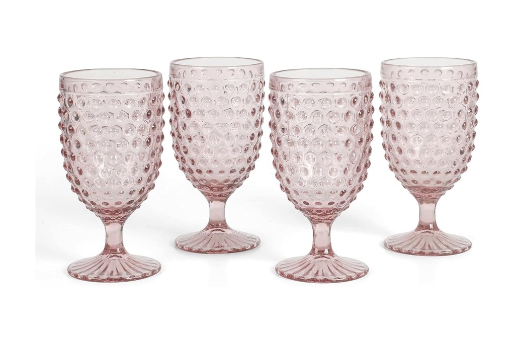 Set of four pink glass goblets with hobnail texture.