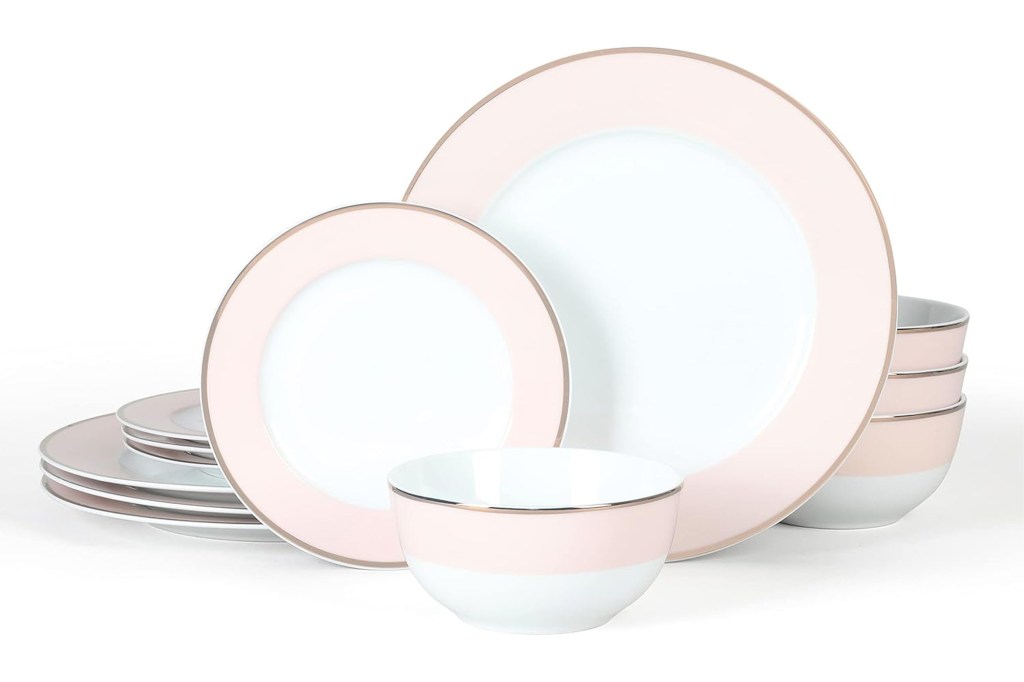 Ceramic dinnerware set with blush pink borders and metallic gold trim.