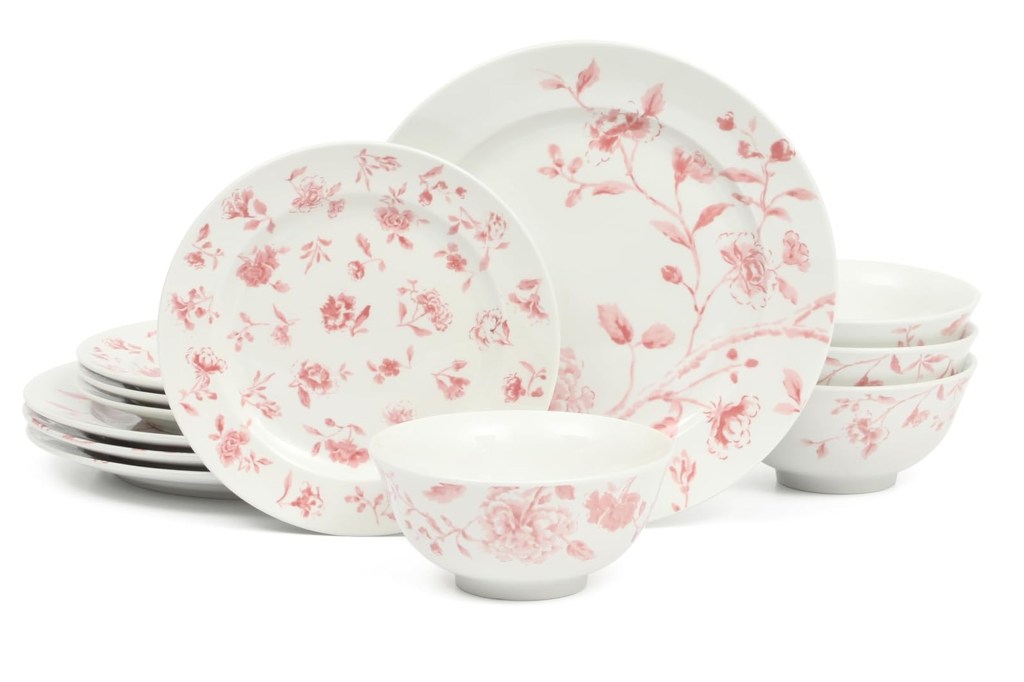 White dinnerware set with pink floral patterns.